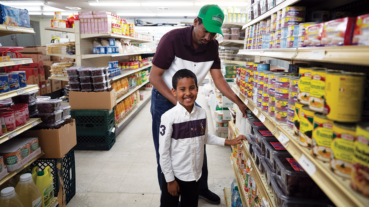 Mohamed and his son in his grocery store, Phoenix Mini Market