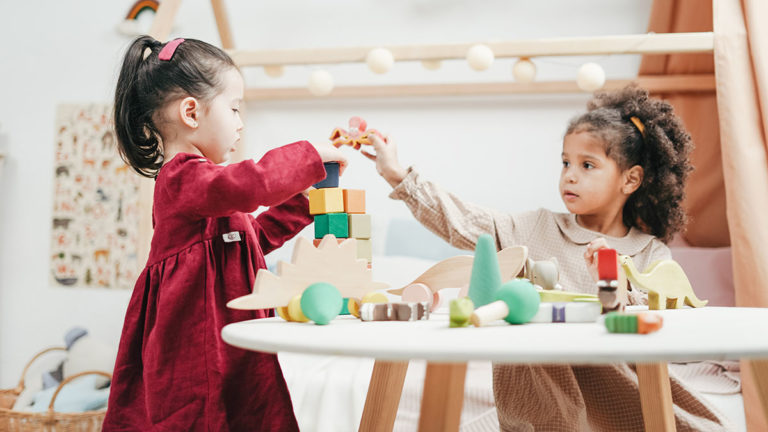 Young girls playing with blocks together